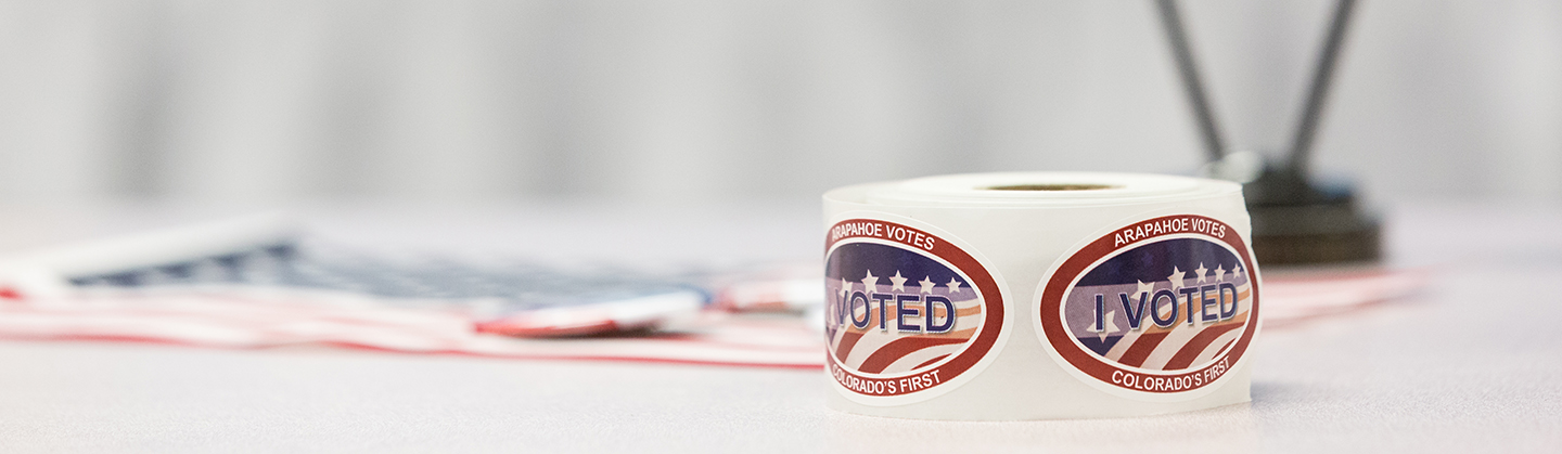 Roll of stickers that read "Arapahoe Votes - I Voted- Colorado's First"