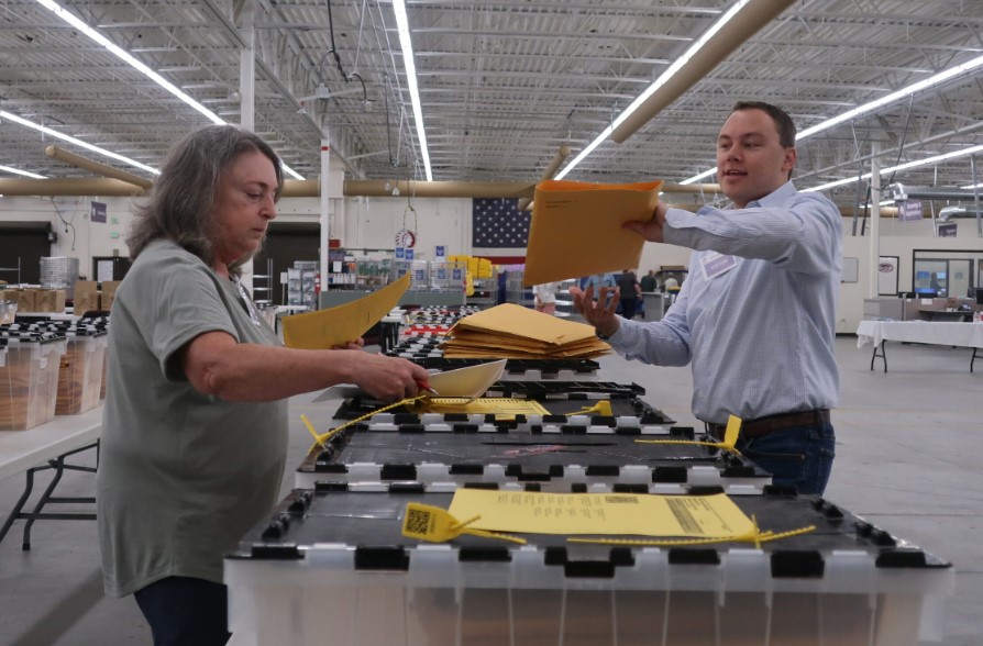 Bi[artisan representatives from Arapahoe County's Democratic and Republican parties pull ballots for the RLA. Photo courtesy of Colorado Public Radio.