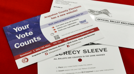 Photo of three envelopes on a red tablecloth