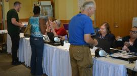 Voters check in at table at Voter Service and Polling Center