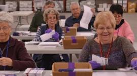 Bi partisan teams of two, open envelopes and remove ballots