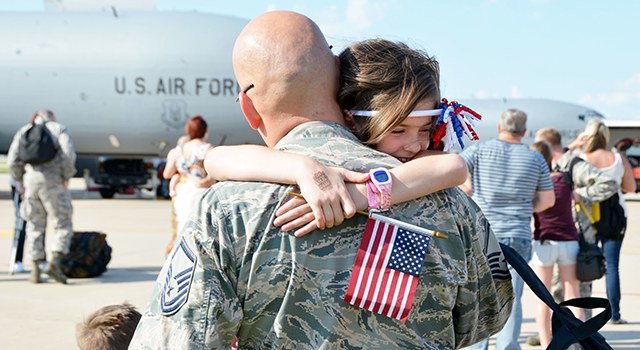 Air Force airman hugs his daughter