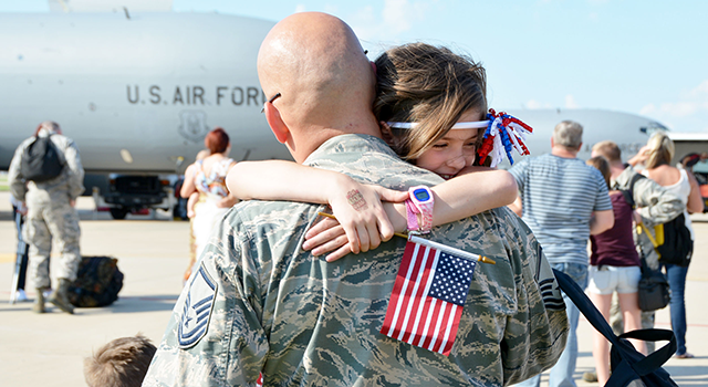 (U.S. Air Force photo/Tech. Sgt. Lauren Gleason/DVIDS 3051648) Air Force airman hugs his daughter